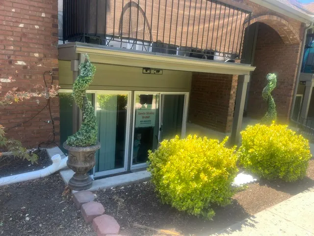Ground-level entry featuring double glass doors and an overhead awning
