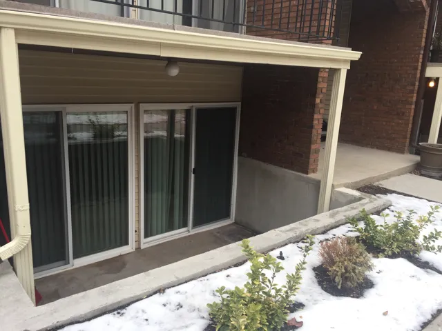 Triple sliding glass doors provide patio access