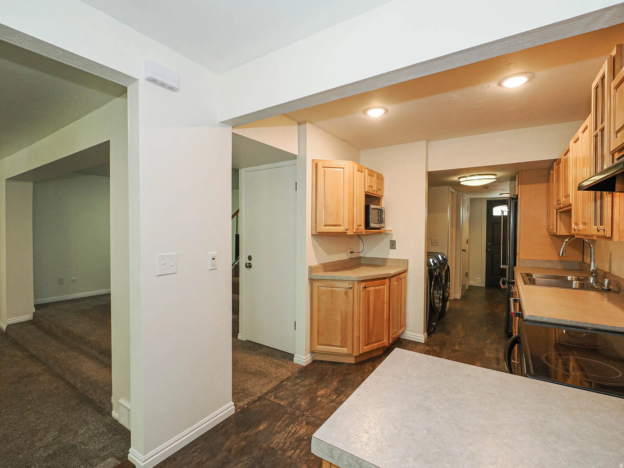 Kitchen featuring natural wood-finish cabinetry, recessed lighting, and a built-in microwave