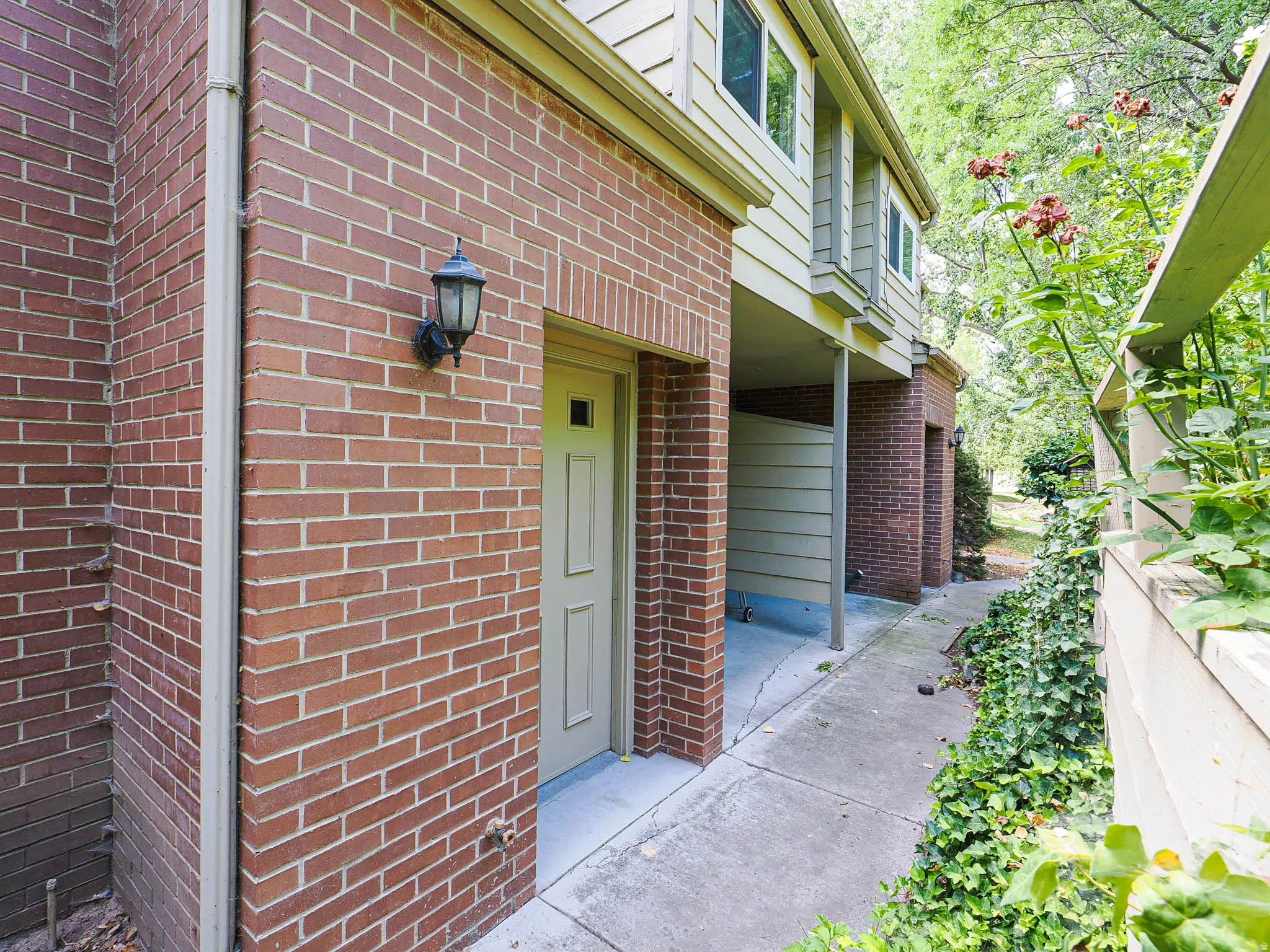 Exterior featuring red brick facade and light-colored siding