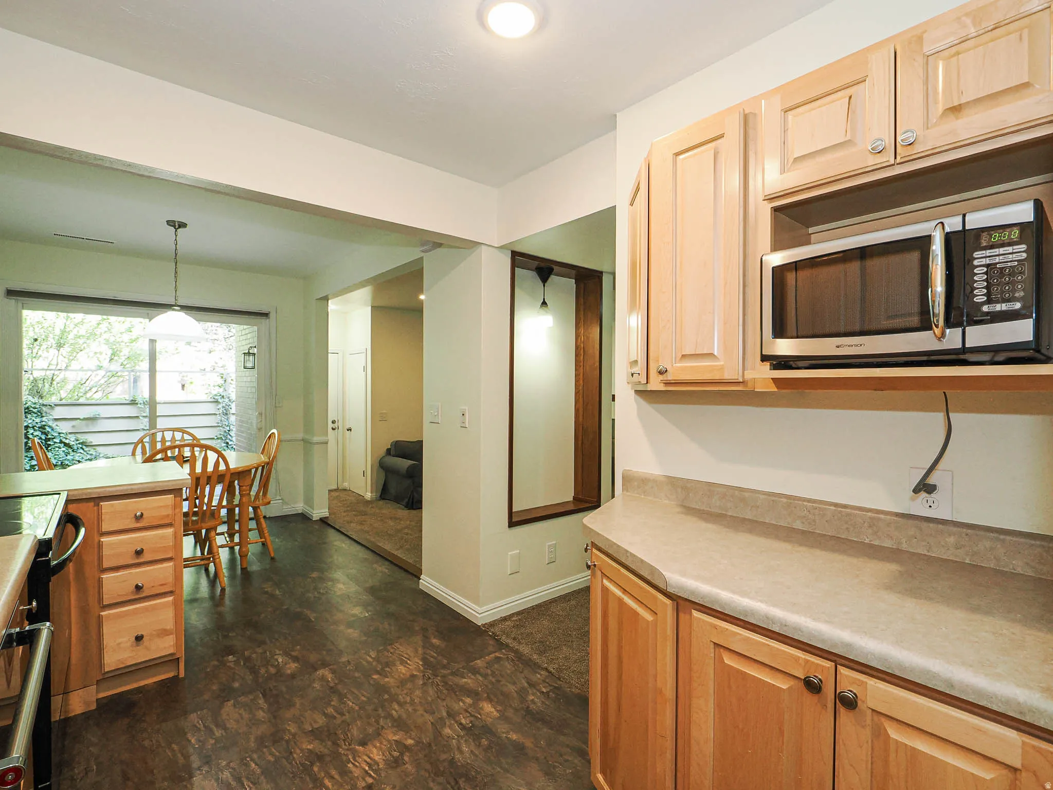 Kitchen featuring wood-finish flooring and light wood cabinetry with brushed nickel hardware