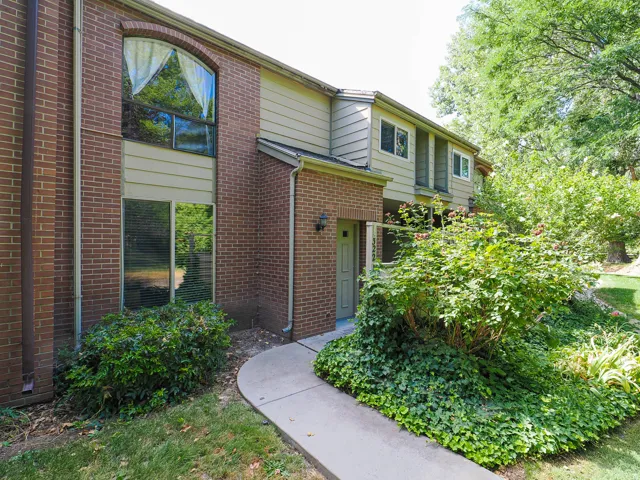 Brick and siding exterior with mature landscaping