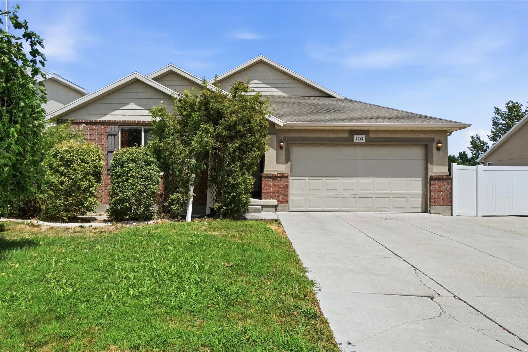 Exterior facade featuring brick accents, horizontal siding, and stucco finishes