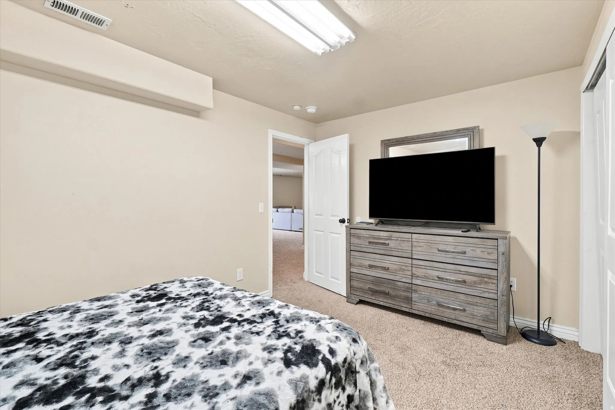 Bedroom #4 featuring light beige walls and white trim