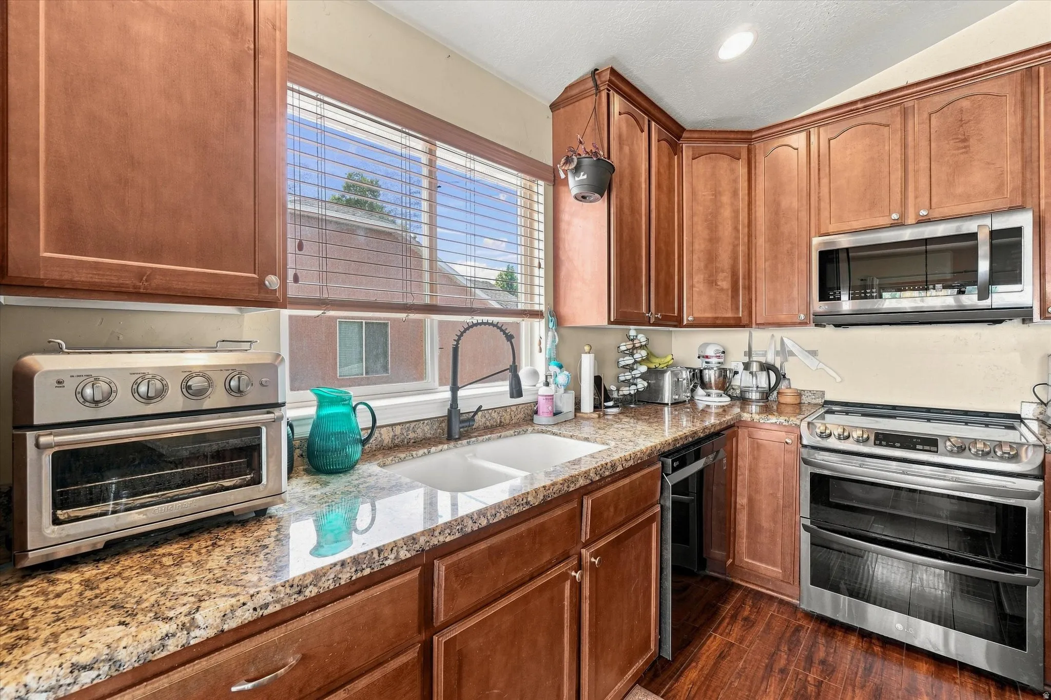 Kitchen featuring rich wood cabinetry and granite-style countertops