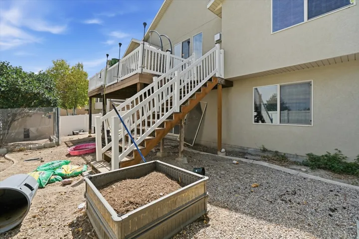 Multi-level deck with white railings and wood-finish stairs