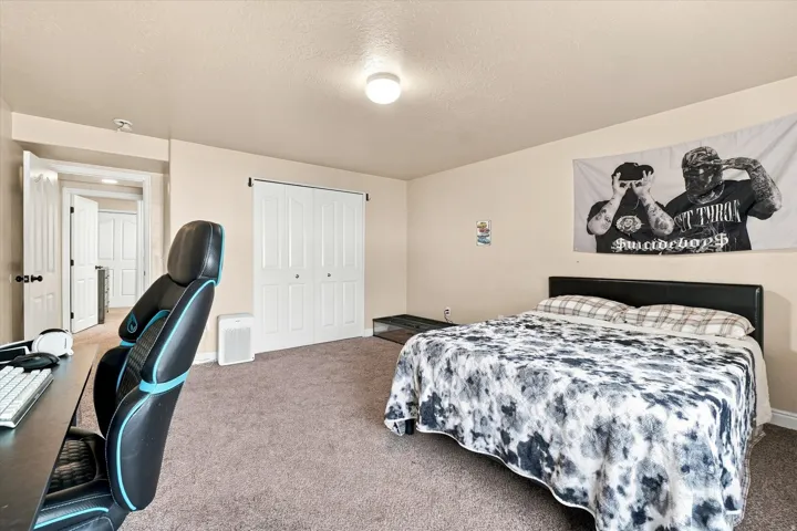 Bedroom #5 featuring a ceiling-mounted light fixture, bi-fold closet doors, and light-toned wall paint