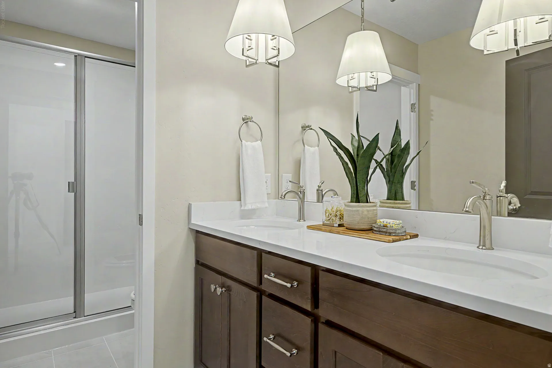 Bathroom featuring a double vanity with stone countertops, undermount sinks, and brushed nickel fixtures