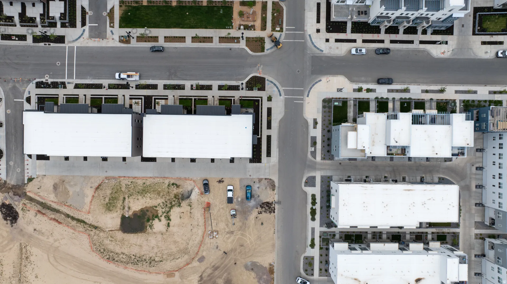 Modern residential development featuring a series of multi-story buildings, integrated street networks, and landscaped green spaces