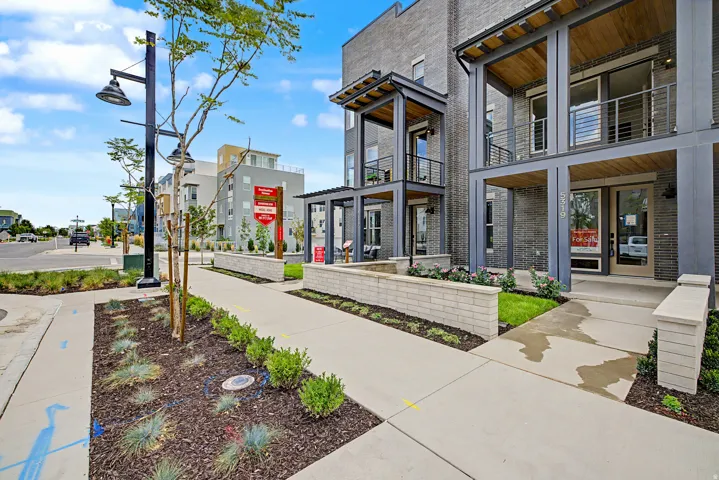 Contemporary multi-story facade featuring dark brick and metal accents