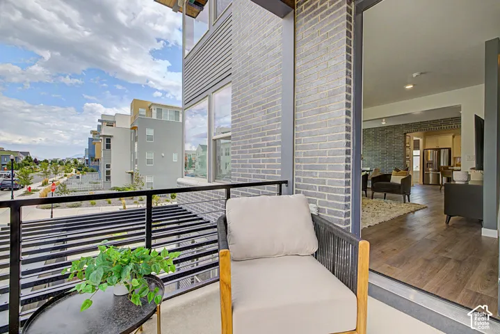 Private balcony featuring a black metal railing and grey brick exterior