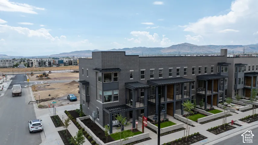 Modern townhome-style residences featuring dark brick and panel siding
