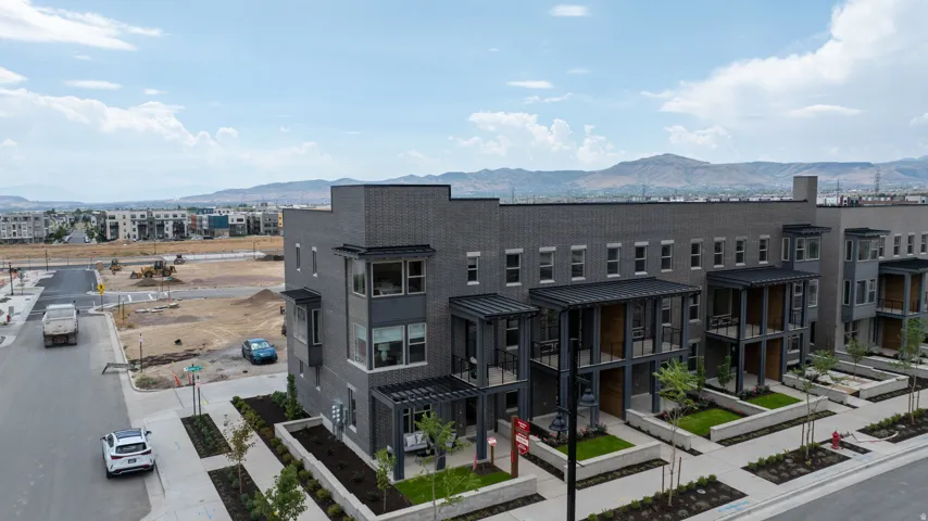 Modern townhome-style residences featuring dark brick and panel siding