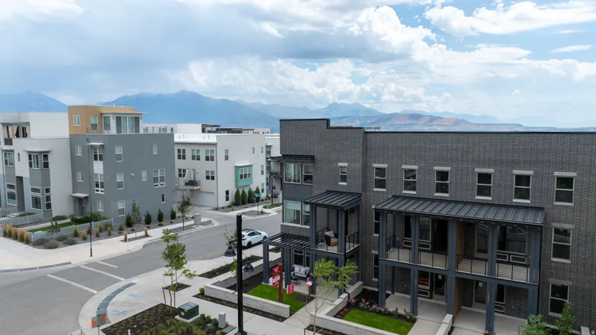 Modern multi-story residential buildings featuring varied facade materials and balconies