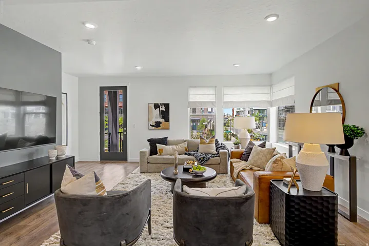 Spacious living area featuring wood-finish flooring, recessed lighting, and expansive windows