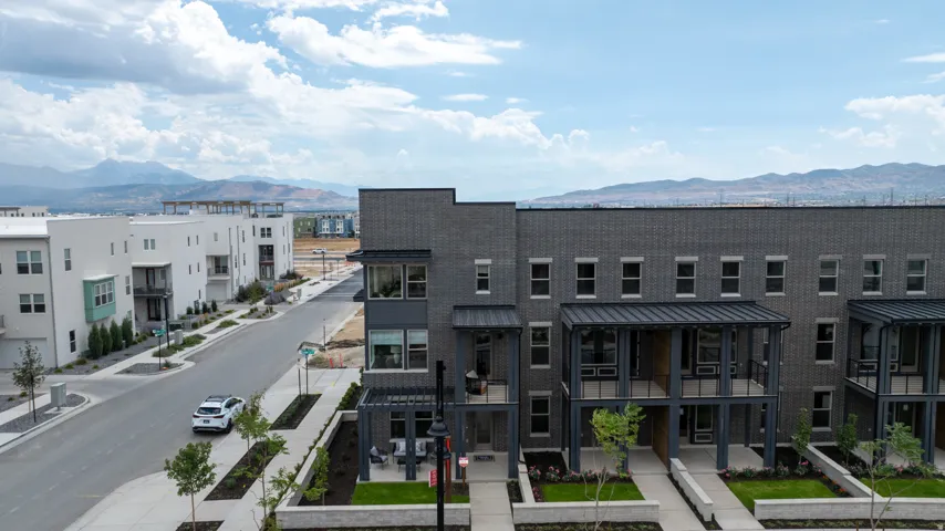 Modern townhome exteriors featuring dark brick and metal accents
