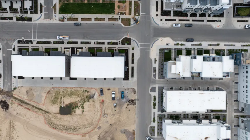 Modern residential development featuring a series of multi-story buildings, integrated street networks, and landscaped green spaces