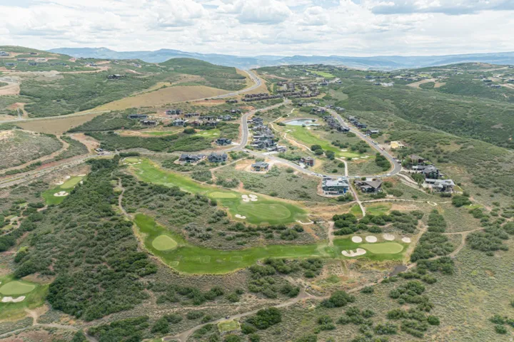 Expansive aerial of a residential development integrated with a golf course