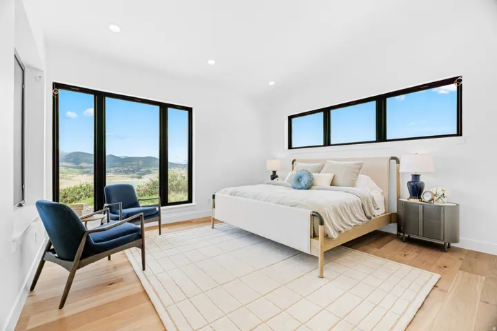 Expansive windows showcasing hillside and distant mountain scenery