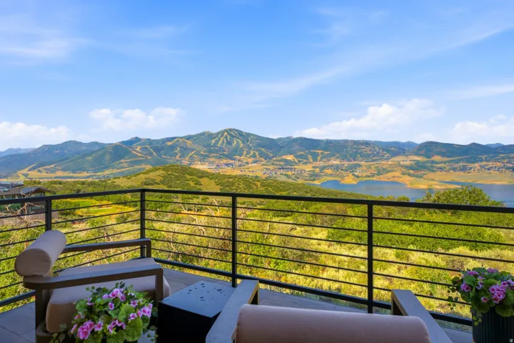 Expansive outdoor deck featuring a sleek horizontal metal railing