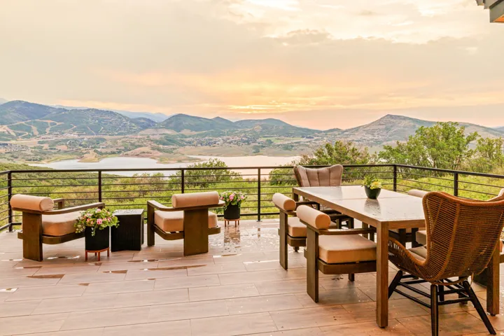 Expansive outdoor deck featuring wood-finish flooring and a black metal railing