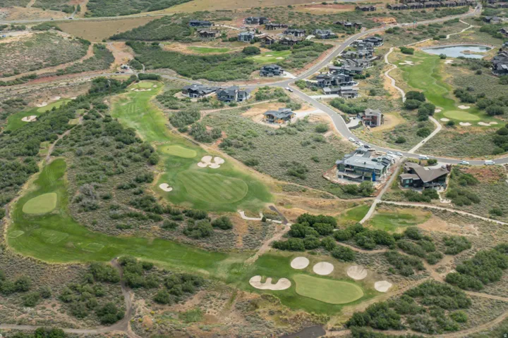 Expansive golf course setting featuring multiple greens, sand bunkers, and fairways