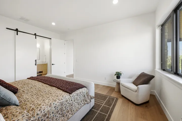 Light wood-finish flooring with white baseboards throughout