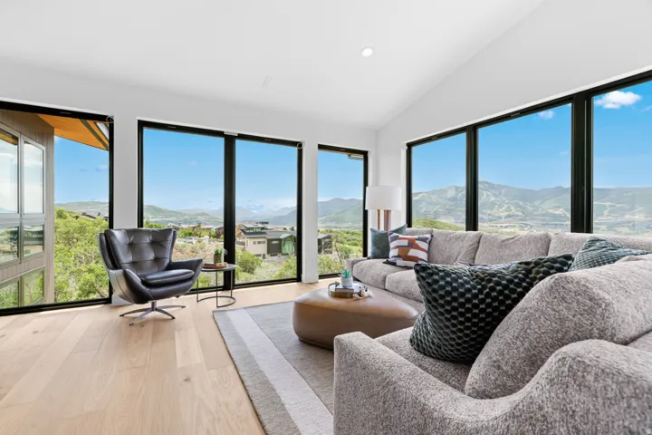 Expansive windows frame panoramic mountain and hillside scenery