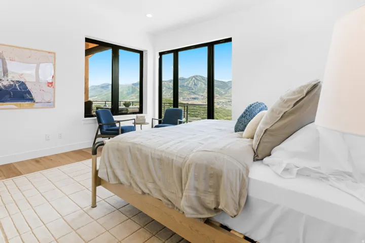 Expansive room featuring multiple black-framed windows showcasing a mountain backdrop