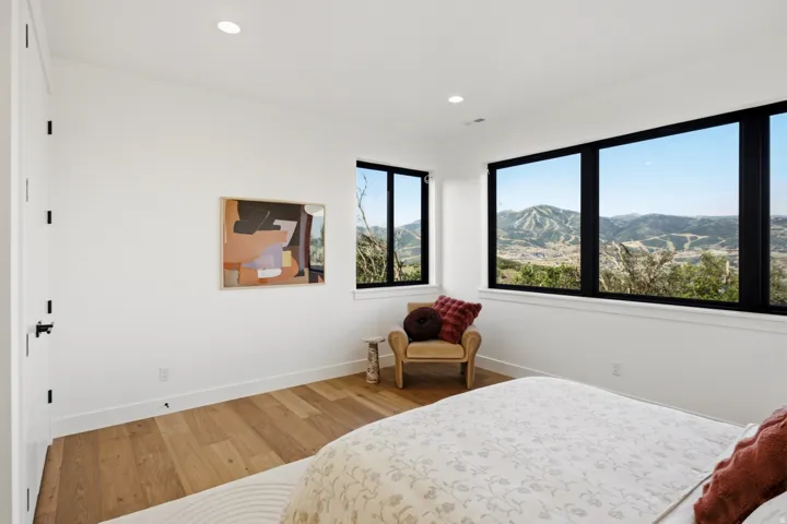 Expansive mountain scenery visible through large black-framed windows