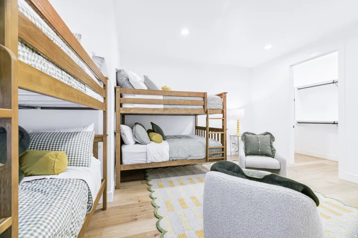 Spacious room featuring light wood-finish flooring and recessed ceiling lighting
