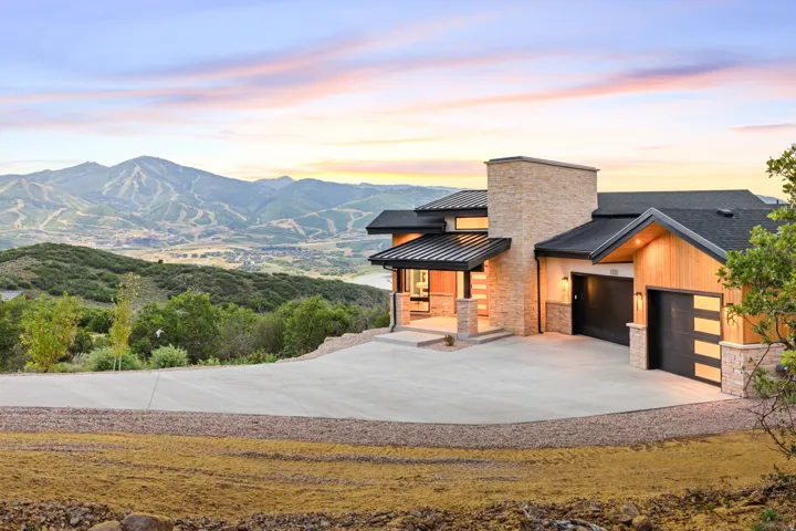 Contemporary architecture featuring stacked stone and natural wood siding