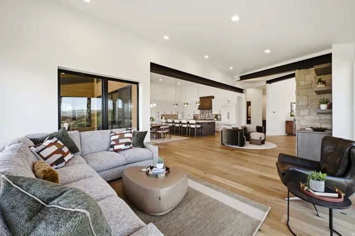 Bright interior featuring wood-finish flooring, recessed lighting, and exposed structural beams