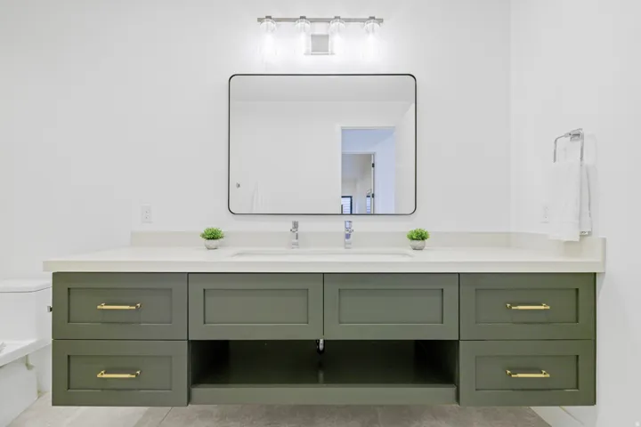 Floating vanity with a light countertop and dual sinks