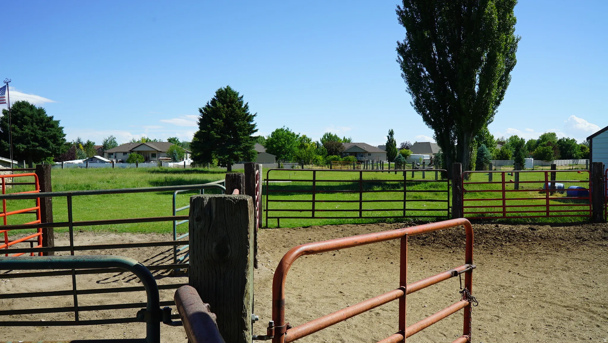 Outdoor fenced area with a dirt ground surface