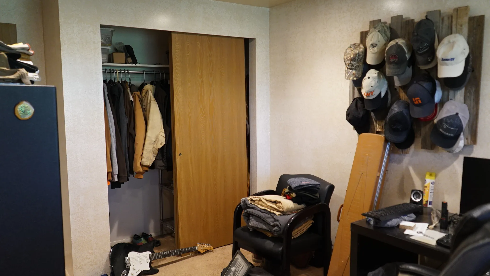 Recessed closet with natural wood-finish sliding doors and a built-in hanging rod