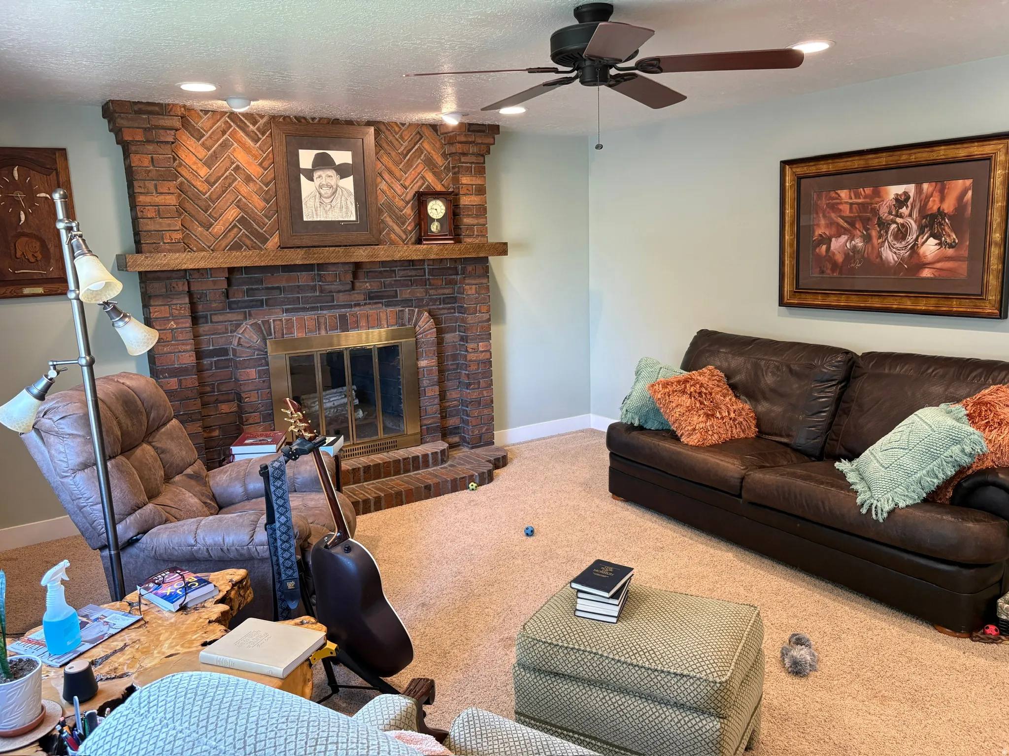 Brick fireplace with a herringbone pattern detail and a wood mantel