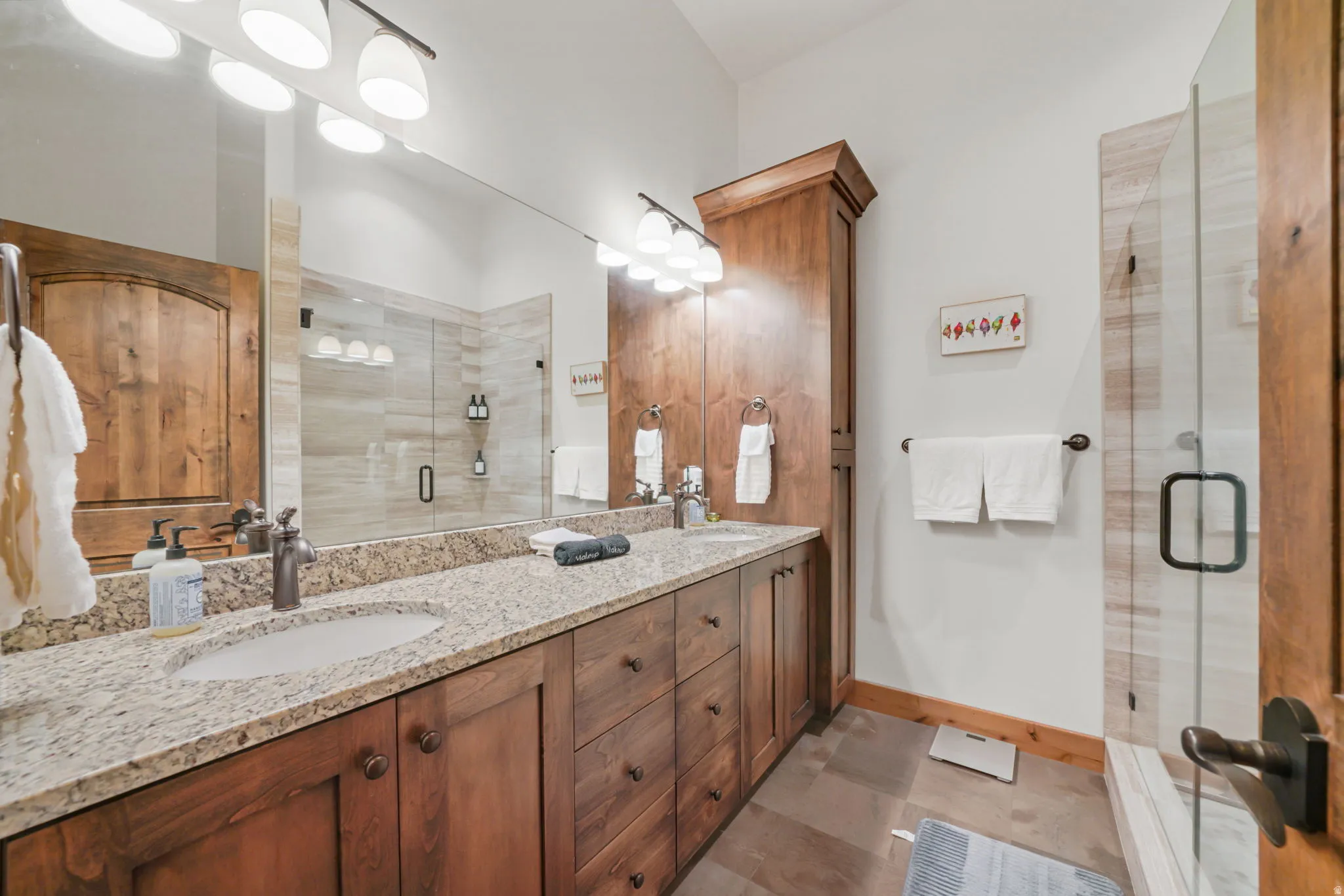 Double vanity featuring granite countertops and undermount sinks