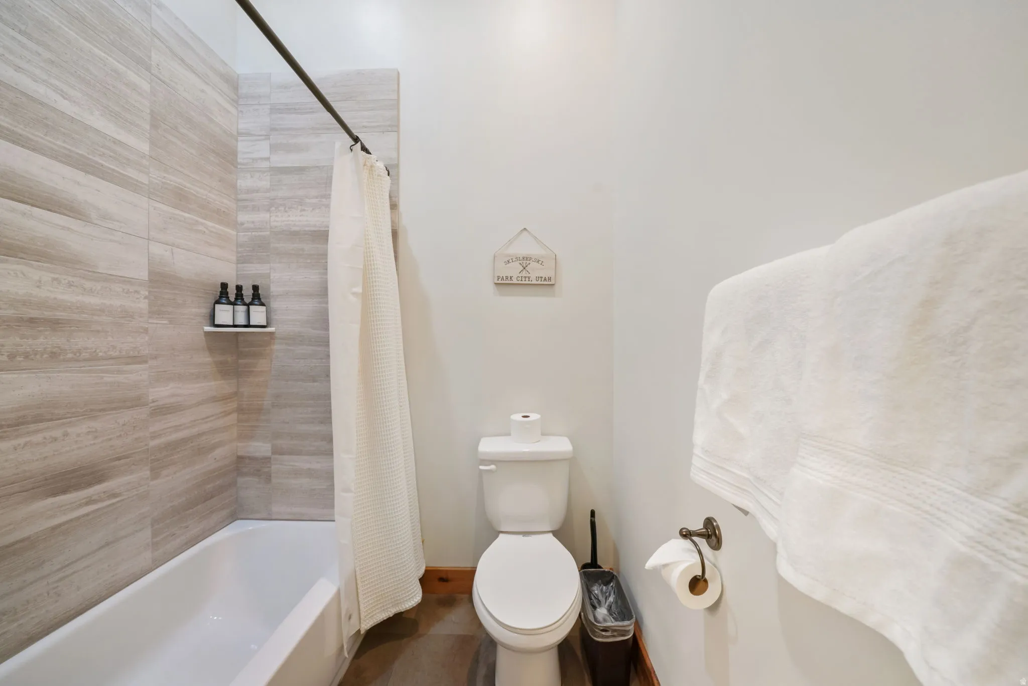 Full bathtub with a single-handle faucet and light-toned tile surround