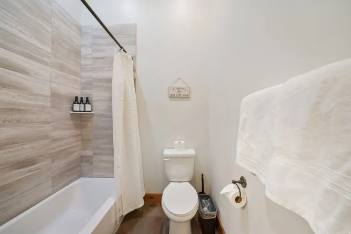 Full bathtub with a single-handle faucet and light-toned tile surround