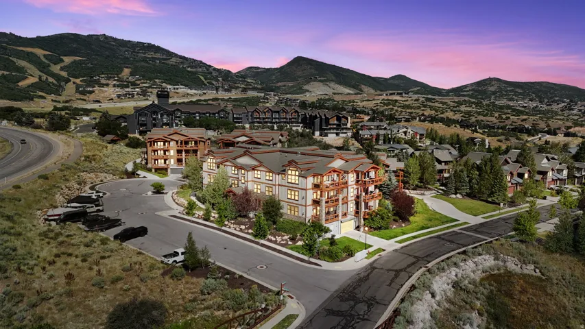 Mountainous landscape featuring multiple multi-story residential buildings with balconies and varied architectural styles