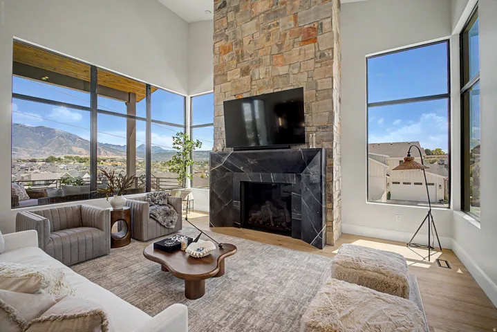 Living area featuring a floor-to-ceiling stone fireplace with a black marble hearth and surround