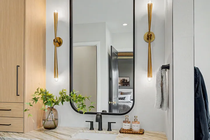 Bathroom vanity featuring a rectangular undermount sink, a stone countertop, and matte black fixtures