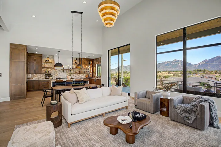 Expansive living area featuring a vaulted ceiling and wood-finish flooring