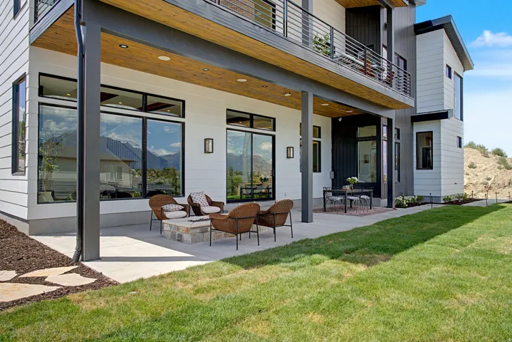 Expansive concrete patio with a built-in stone fire pit