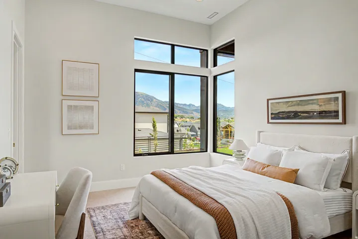 Corner window installation with black frames overlooking mountain scenery