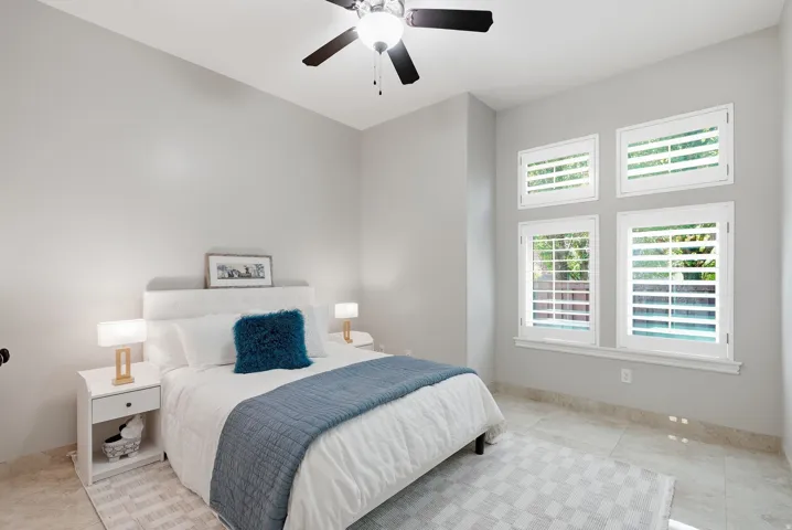 Recessed lighting and ceiling fan complement the neutral wall tones