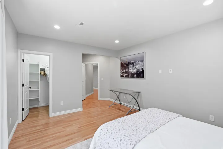 Room featuring light wood-finish flooring, light gray walls, and recessed ceiling lighting