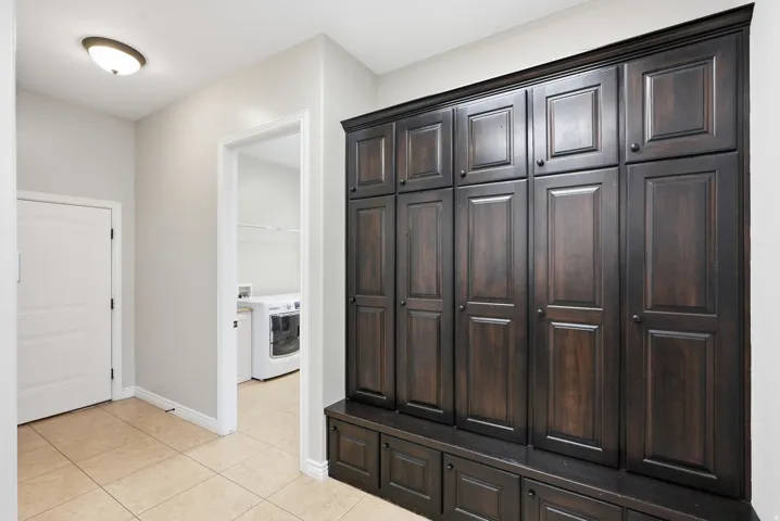 Built-in dark wood cabinetry with panel doors and lower storage compartments
