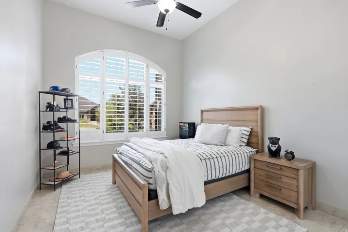 Arched window with plantation shutters